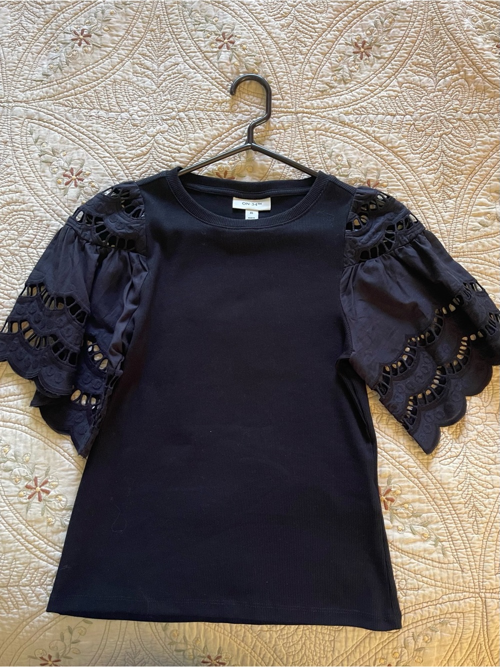 ON 34th Black Eyelet Puff-Sleeve Knit Pullover. Cotton sleeves with knit body.
